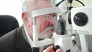 examination of elderly man with slit lamp. equipping ophthalmologist's office.