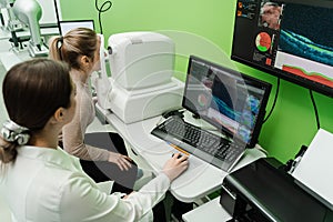 Examination of eyes of patient using optical coherence tomograph. Optical coherence tomography OCT scan to create