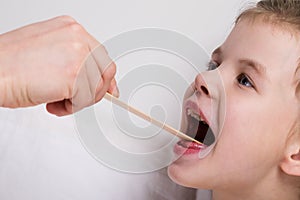 examination of the throat of a little girl, a little girl opened her mouth wide