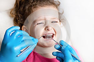 Examination, treatment teeth children. medical checkup oral cavity with instruments. dental hands, child in clinic.