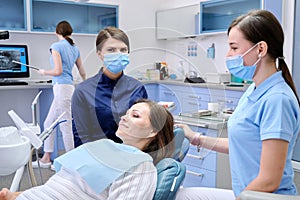 Examination, treatment of teeth, patient mature woman in dental chair