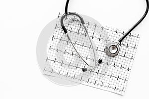 Examine the heart to prevent heart disease. Stethoscope and cardiogram on white background top view copyspace