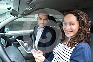 Examiner delivering driing licence to woman