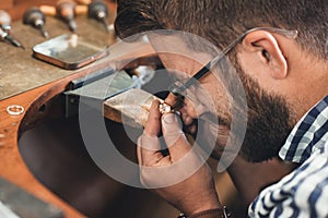 Examining the centerpiece gem for his new jewelry design