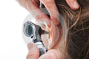 Examining ear with otoscope