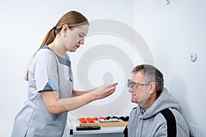 Examining patient vision. Eye exam. Optometrist checking patient eyesight and vision correction. Patient undergoing