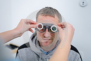 Examining patient vision. Eye exam. Optometrist checking patient eyesight and vision correction. Patient undergoing