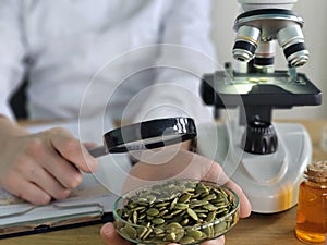 Examining pumpkin seeds under a microscope in a laboratory
