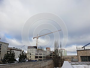 example of point construction in a residential area. crane on the site of the building under construction