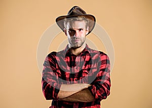 Example of true masculinity. Cowboy wearing hat. American cowboy. Western life. Man unshaven cowboy beige background