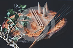 Examples of various types of incense - long black sticks, short hand made sticks and  small triangular cones