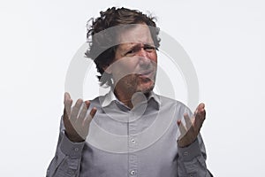 Exasperated man making hand gestures, horizontal photo