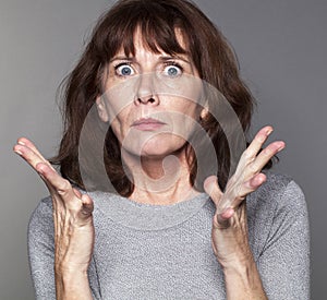 Exasperated mature woman with tense eyes wide open