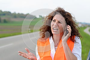 Exasperated young female driver on her mobile photo