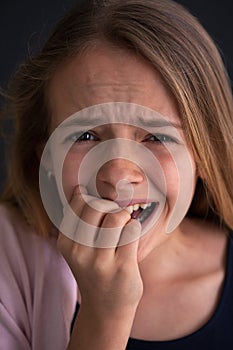 Exasperated young girl covering her mouth with her hand