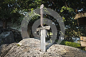 Excalibur, King Arthur\'s sword in stone. Edged weapons from the legend Pro king Arthur