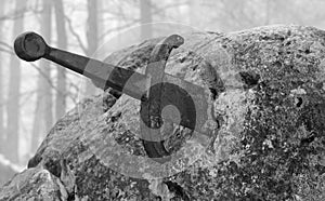 Excalibur sword into the stone with balck and white toned effect