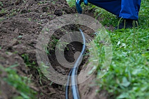 Excavated earth trench for pipe-laying of communication and electrical wiring under the ground to provide water to residential