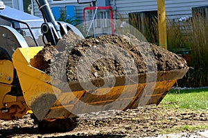 Excavating bucket full of dirt