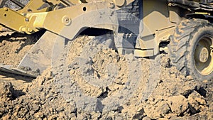 Excavating of hole. Yellow digger works on building. Construction machinery, ground works.