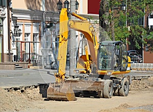 Excavating machine on road site