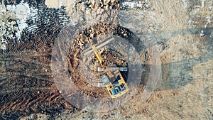 Excavating machine is transporting a piece of metalware in a top view