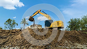 excavating soil into a dump truck to build a pond for store water for use in the dry season for agriculture