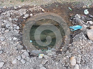 excavation of the road to expose a leaking water pipe line