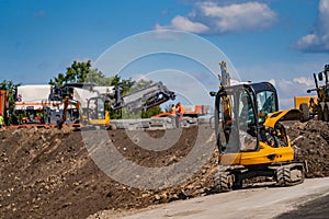 Excavation work on the construction of rural roads. Heavy special machinery. Road repair concept.
