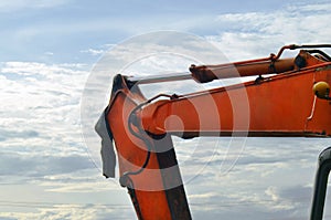 Excavator arm close-up with sky background