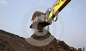 Excavator arm moving soil