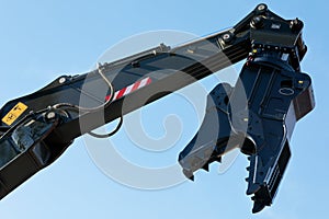 excavator arm with rotating crusher attachment