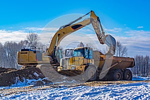 excavator and articulated dump truck