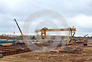 Excavator and auto crane working at construction of a new metro line.