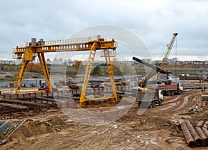 Excavator and autocrane working at construction of a new metro line.