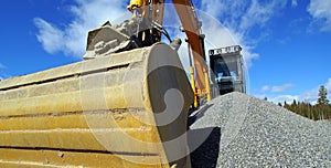 Excavator bucket against blue sky