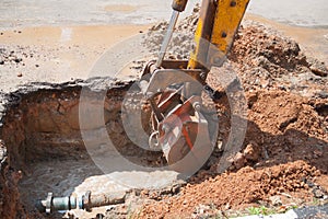 Excavator bucket bulldozer work a hole the repair of pipe water