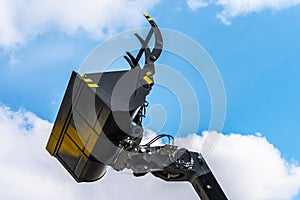 Excavator bucket close-up on ble sky. Industrial Excavator Machine, Focus On Excavator Bucket