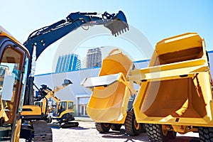 Excavator with bucket and dump truck