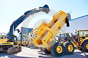 Excavator with bucket and dump truck