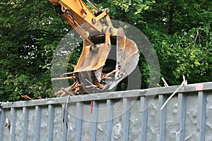 Excavator bucket dumping photo