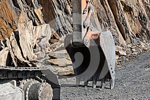 Excavator bucket. Heavy machinery on road works.