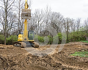 Excavator Bucket Lowering to Scoop Dirt