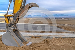 Excavator bucket with view of mountain and sky