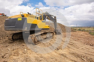 Excavator building a road in a site construction