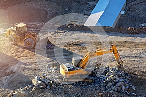 Excavator and bulldozer in construction site. Excavation is the process of moving earth