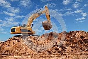 Excavator bulldozer in sandpit photo