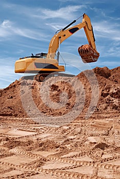 Excavator bulldozer in sandpit photo