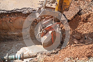 Excavator, bulldozer work a hole the repair of pipe water