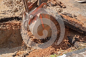 Excavator, bulldozer work a hole the repair of pipe water